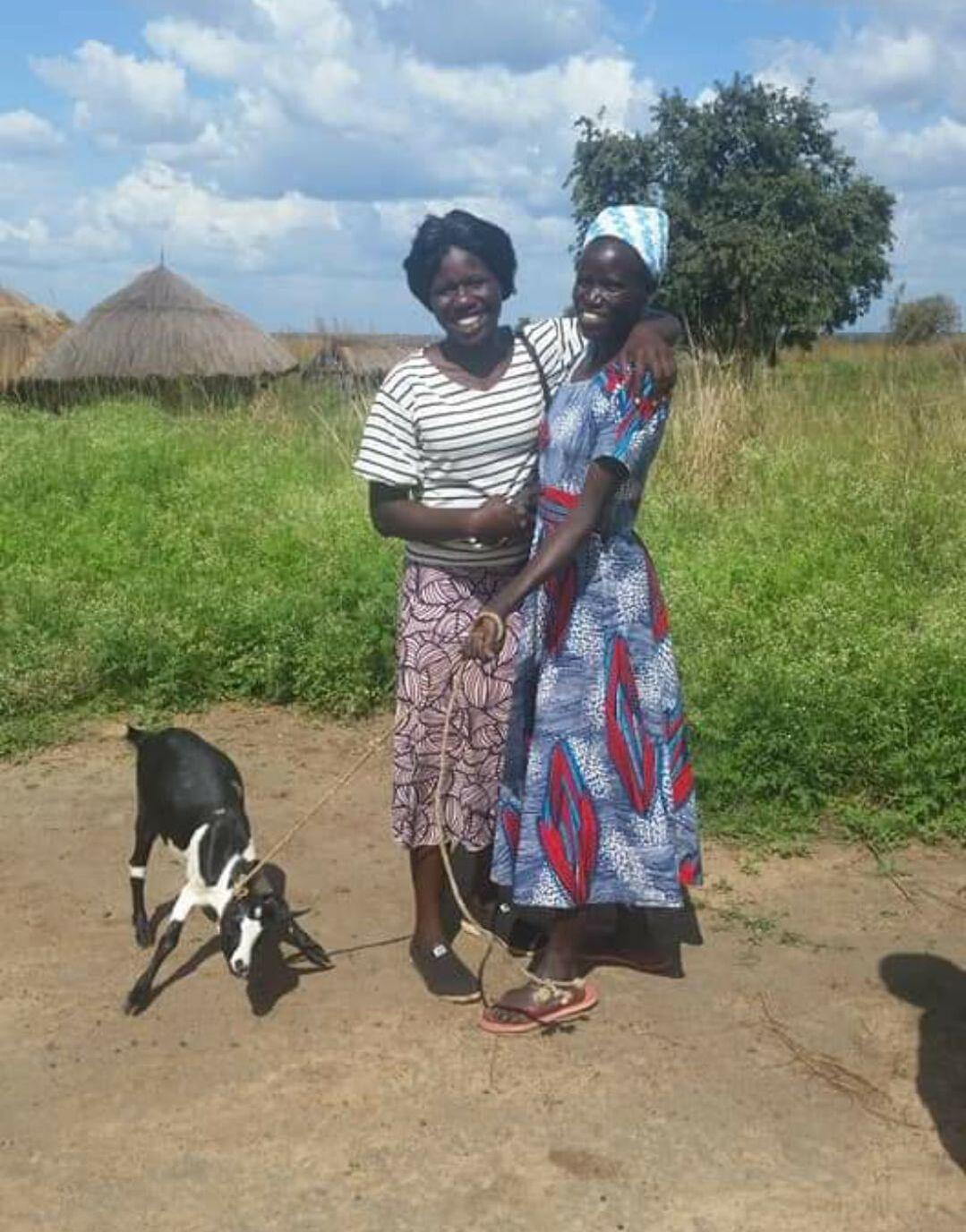 Sophia Muhidini is getting congratulations by her neighbor of she have received a goat donated by Tom Paladino for Wami-Sokoine women in Morogoro