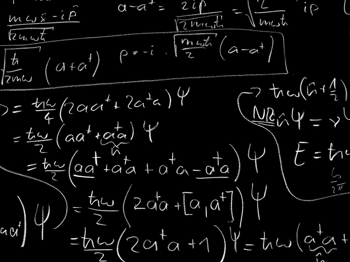 a portion of Quantum Mechanics Formula written in white chalk on a black board