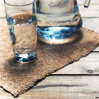 Glasses of water on a wooden table.