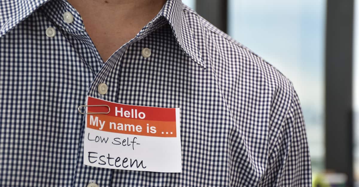 A man with a name tag indicating his low self esteem