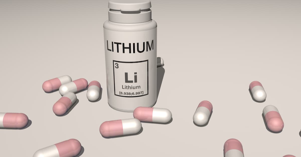 Medicine tub with the word lithium on it and tablets surrounding it
