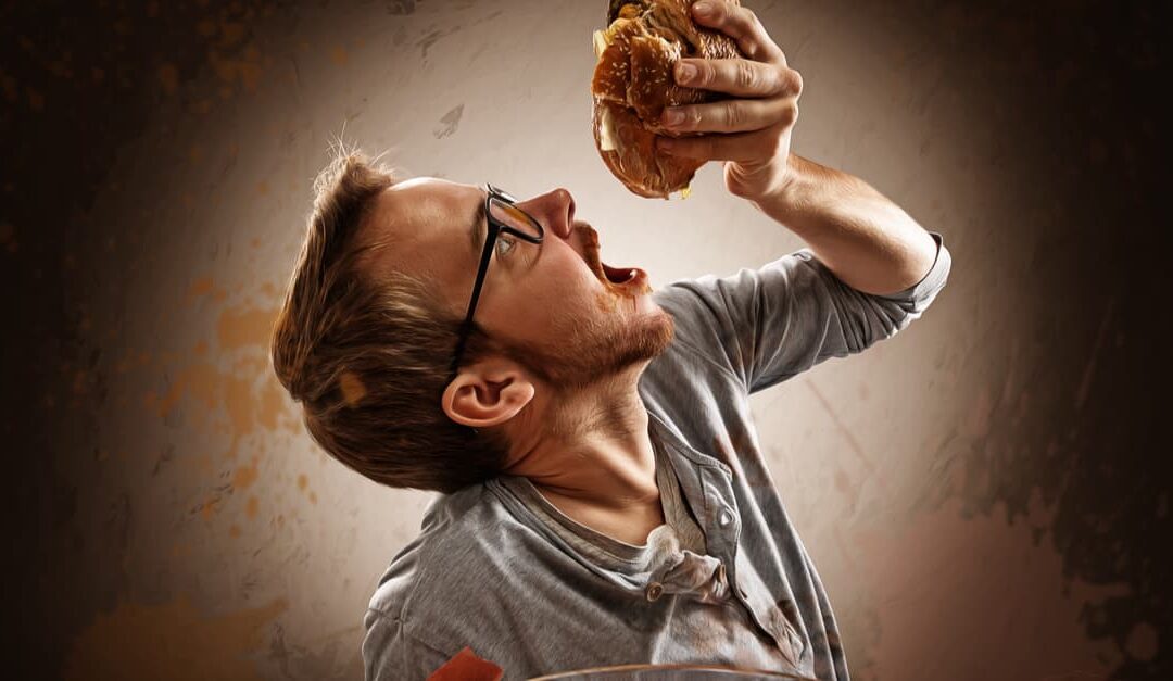 Man eating burger addicted to food