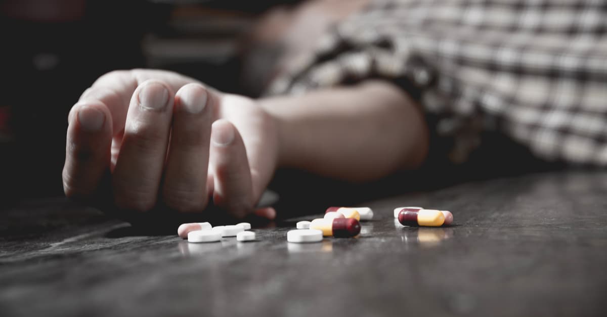 man laying on floor after overdosing on prescription medication