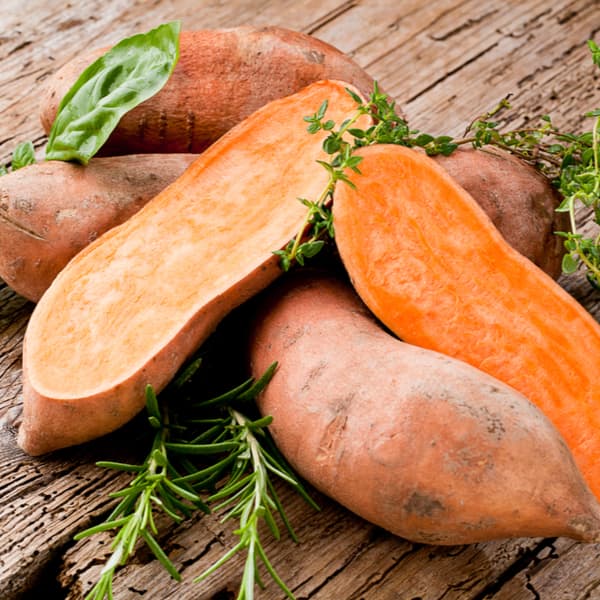Sweet potatoes on Wooden background.