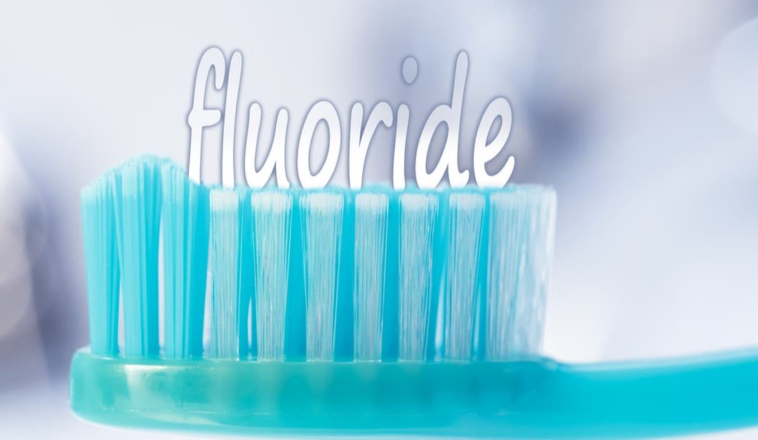 Toothbrush and the word fluoride that is used to prevent tooth decay