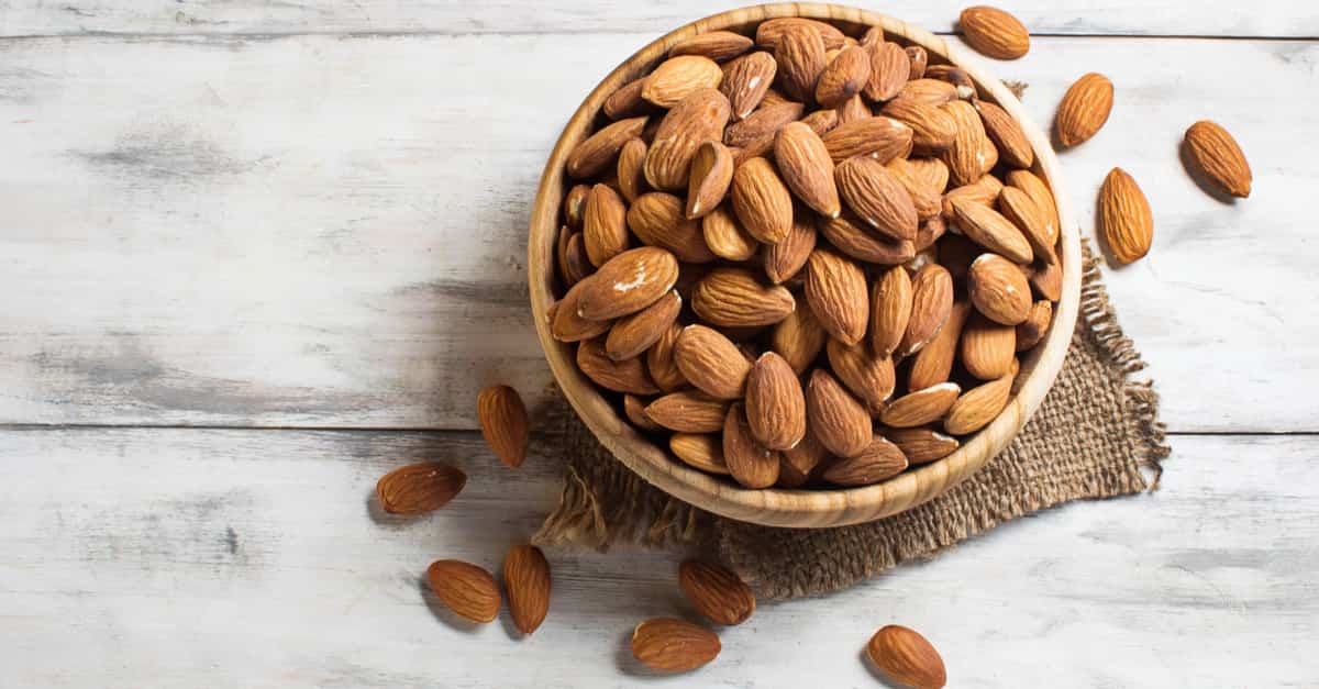 A brown bowl full of almonds, which are capable of increasing GABA levels