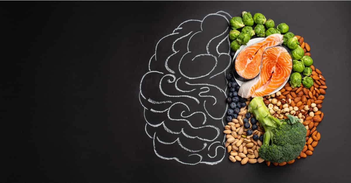 Hand drawn chalk picture of the brain with assorted food for brain health and good memory